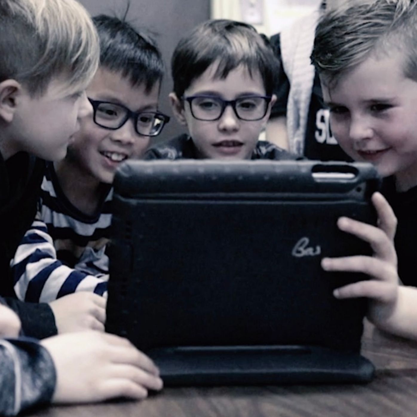 Groupe d'enfants qui visionne du contenu sur une tablette