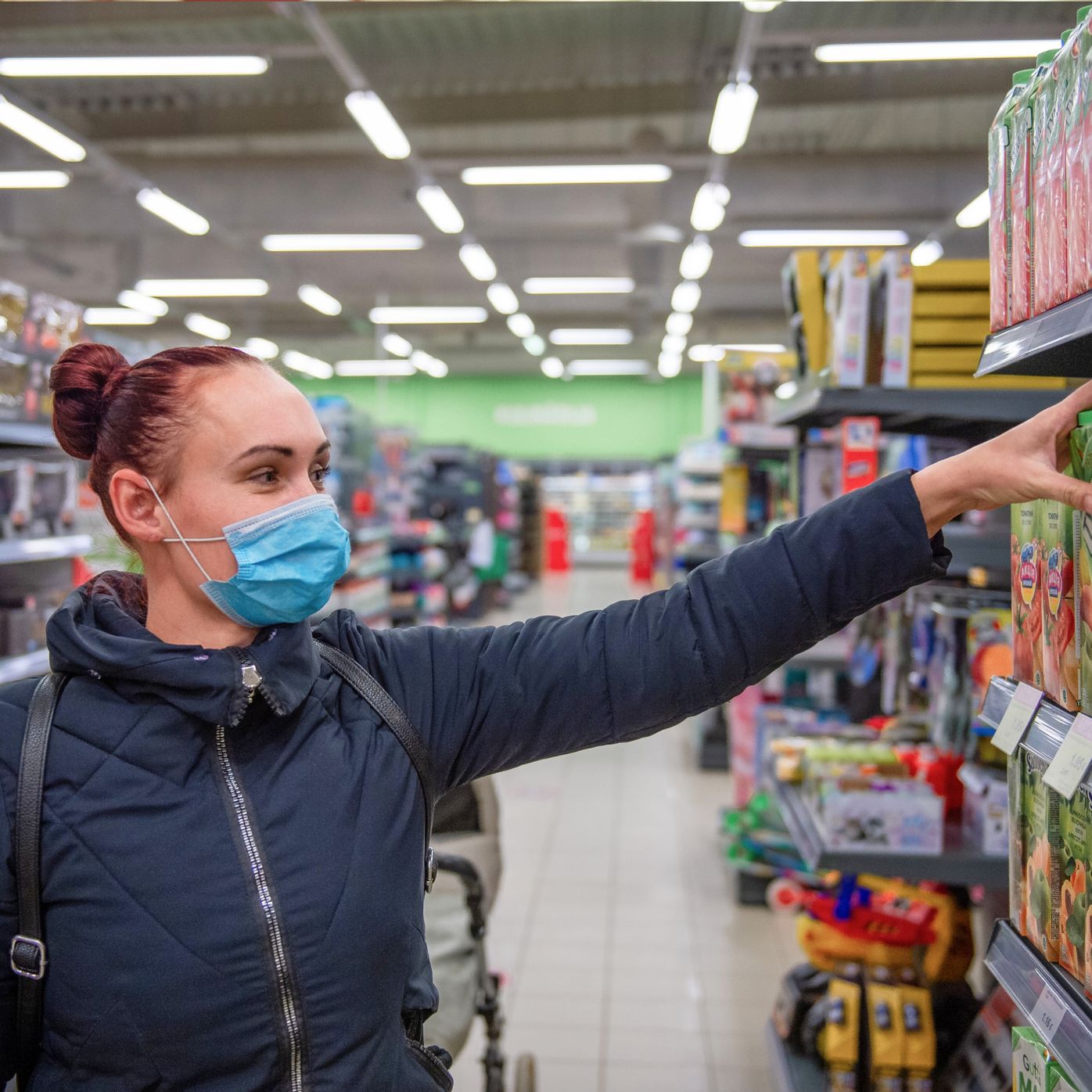A shopper in a store aisle with a mask 