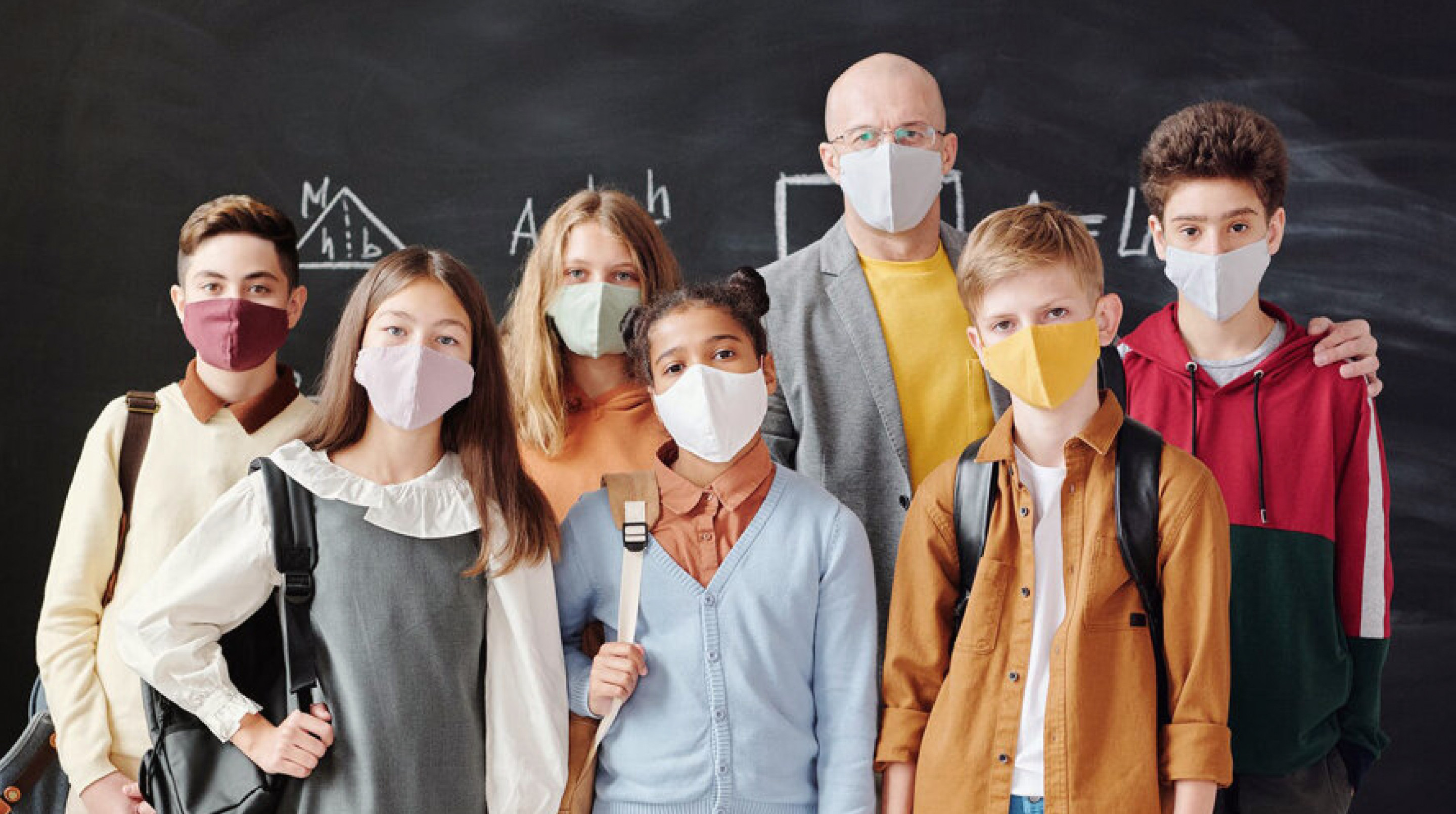Children and professor wearing masks